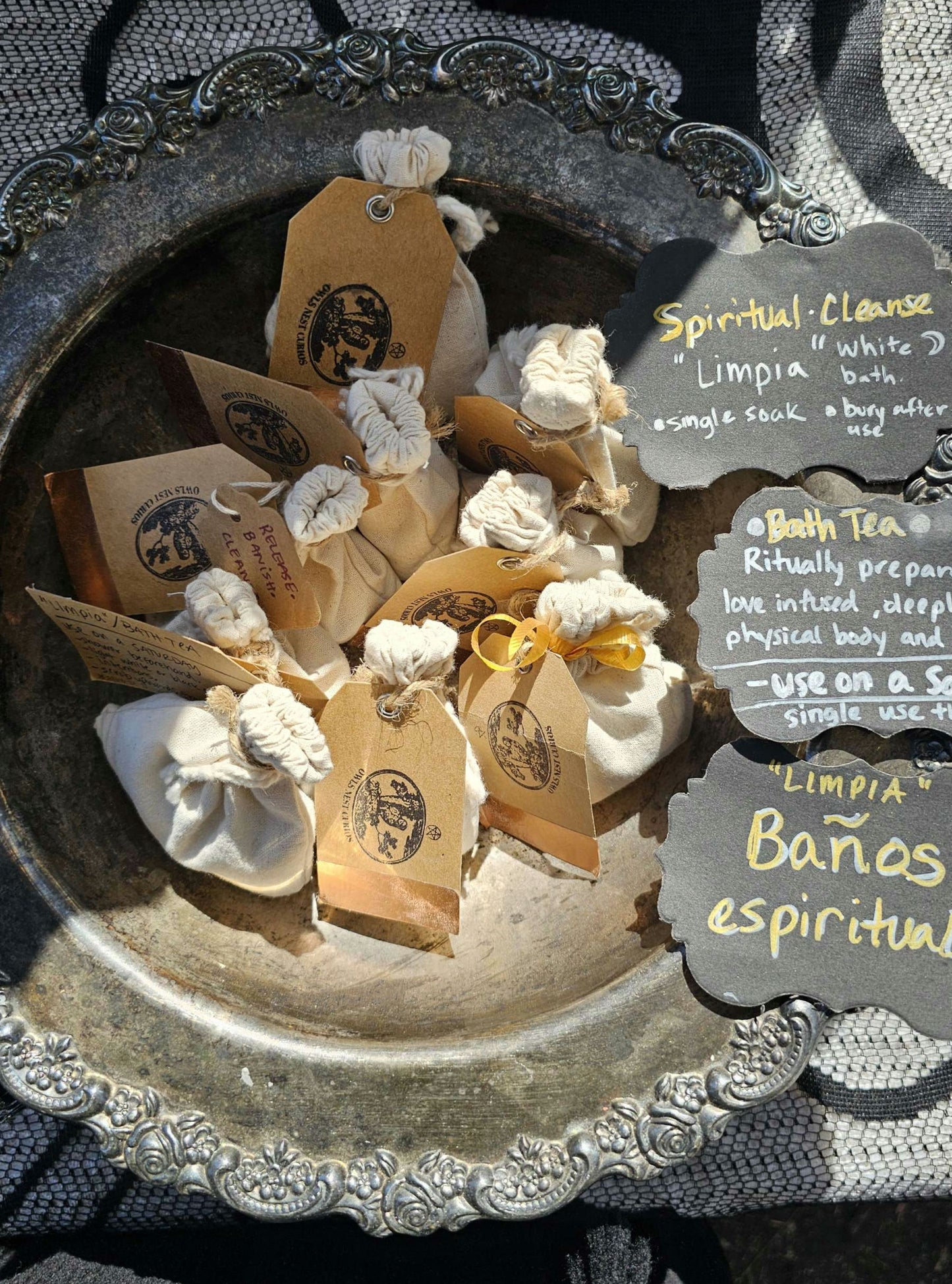 Small bags with labels on a decorative metal tray